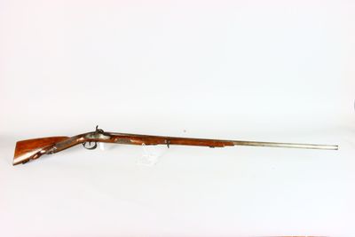 an old rifle with a wooden handle and a wooden barrel
