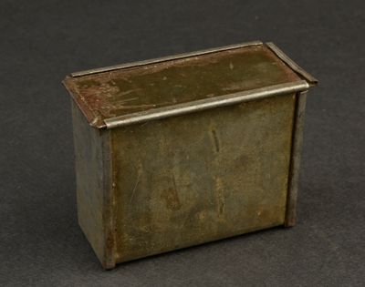 an old metal box sitting on top of a black surface