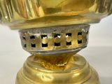 a gold vase on a white table with a white background