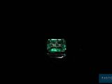 a green emerald stone on a black background