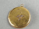 a close up of a gold locke with a bee on it