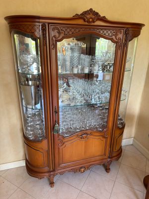 a glass cabinet with a lot of wine glasses in it