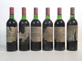 four bottles of wine are lined up in a row