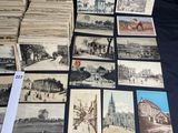 many old postcards on a table with a lot of them