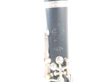 a close up of a clarinet that is on a white surface