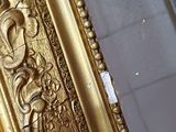 a gold frame with a picture of a bird on it