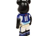 the bear is wearing a blue and white uniform and holding a football jersey