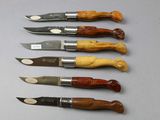 six different types of knives are lined up on a table