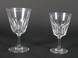 two clear wine glasses sitting on top of a black table