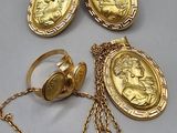 four pieces of gold jewelry including a locke, ring, and chain