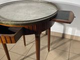 a small table with a marble top and a drawer underneath it