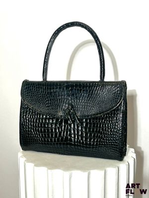 black alligator skin handbag on a white radiator radiator radiator radiator radiator radiator radiator radiator