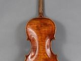 an antique violin with a wooden back and bow