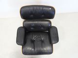 an image of a black leather chair and ottoman in a room