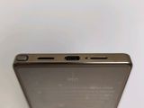 a close up of the back of a gold phone