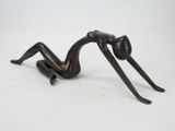 statue of a woman laying down on her back with her legs crossed