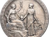 an image of a silver medal with a woman and a man on it