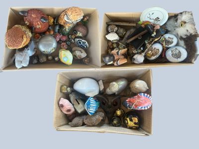 two boxes filled with assorted items on top of each other