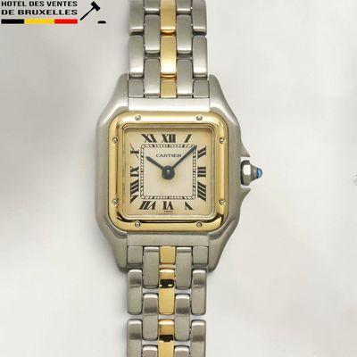 an image of a silver and gold wrist watch with roman numerals