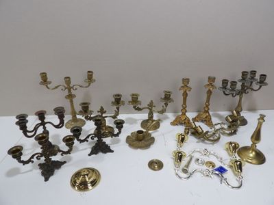 many different types of brass candlesticks on the table