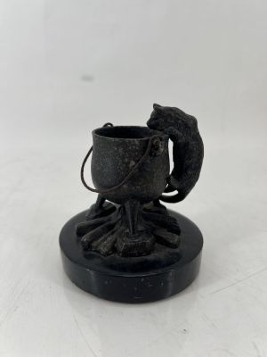 a small statue of a bird on top of a cup