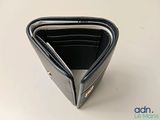 a black wallet that is open on a white table