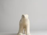 a figurine of a polar bear on a white surface