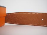 an orange leather belt with a white stitching on the side of it