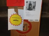 a cardboard box that has a sign on it