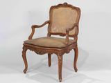an image of a wooden chair with a cane back and seat