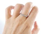 a woman ' s hand with a diamond ring on it
