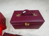 a red suitcase and a red box on the floor