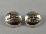 a pair of silver earrings with a crown on them