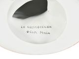 a white plate with a black and red design on it