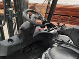 a forklift that is parked in front of a building