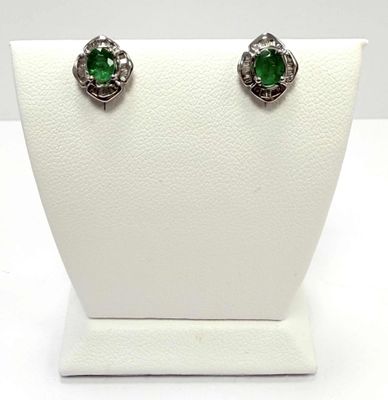 an image of a pair of earrings with green stones