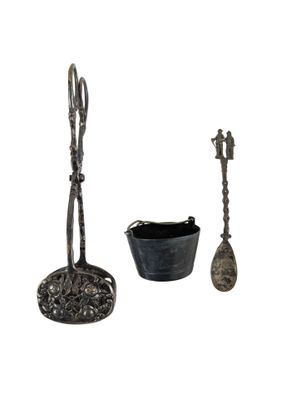three pieces of silverware including a spoon, spoon and spoon rest