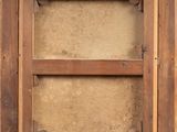 an old wooden window with a brown frame on the outside of it