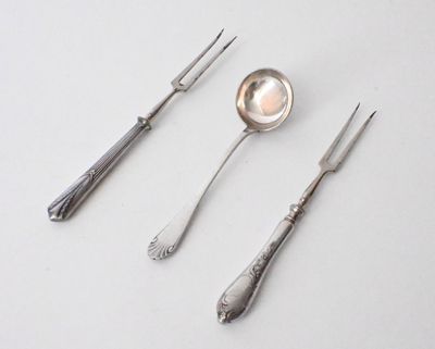 three spoons and two forks sitting on a table