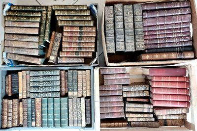 boxes of old books are stacked on top of each other