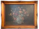 painting of a vase of flowers in a gilded frame on a white wall