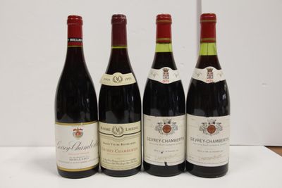 four bottles of wine are lined up on a table