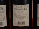 three bottles of wine sitting on a table with a barcode on the label