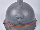 an old helmet with a leather band on a white surface
