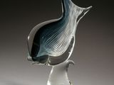 a glass sculpture of a fish on a clear base