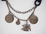an image of a necklace with coins and charms attached to it