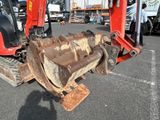 a red excavator that is sitting in a parking lot