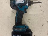 a close up of a cordless drill on a table