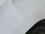 a close up of a white car with a flat tire