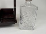 a glass bottle sitting next to a wooden box